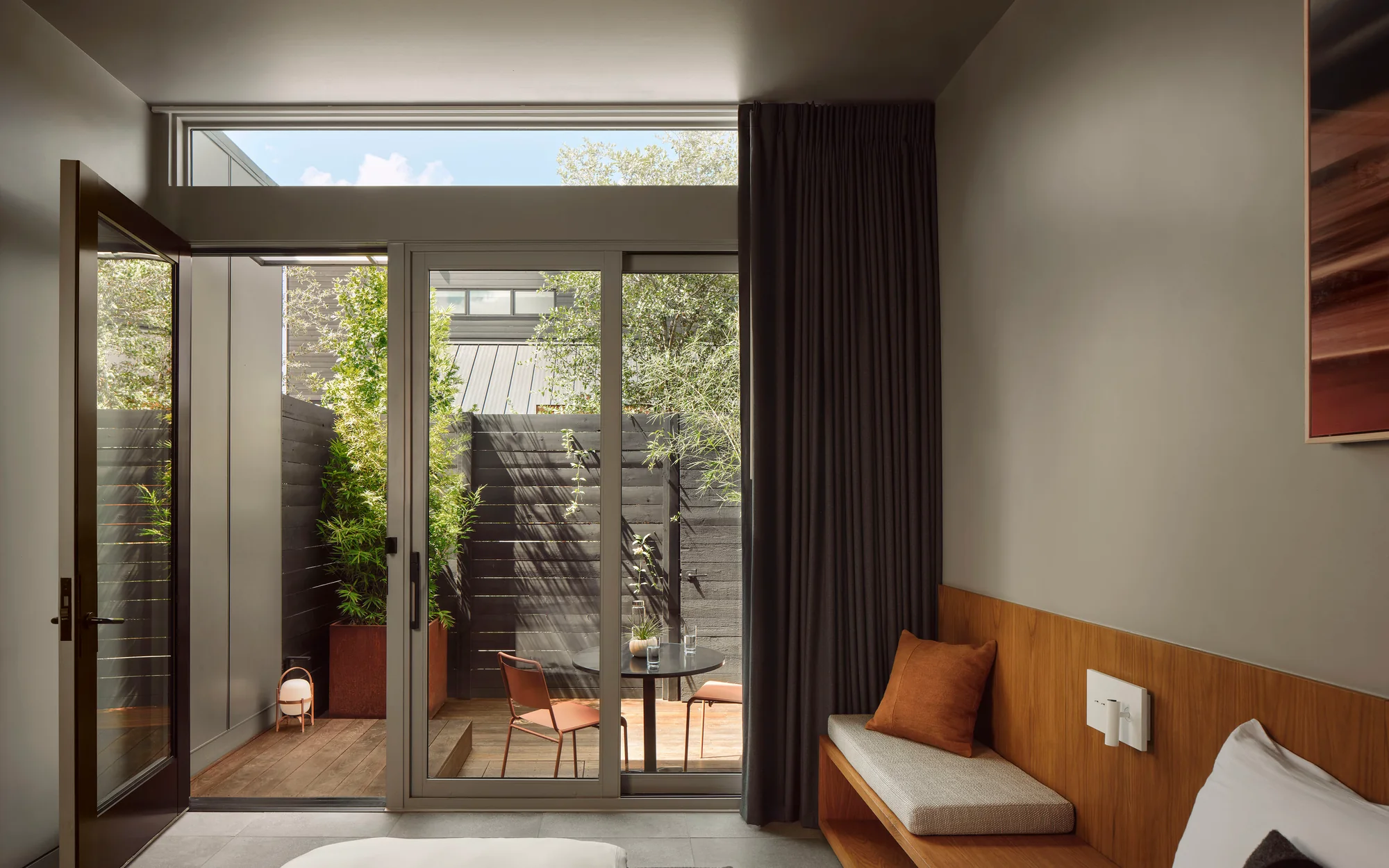 Frame Hotel SoCo — King Suite bed opening to the private lanai