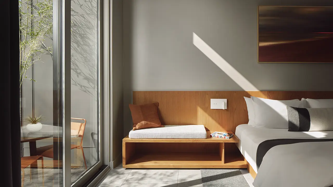 Frame SoCo walkway with built-in bench and soft evening lighting