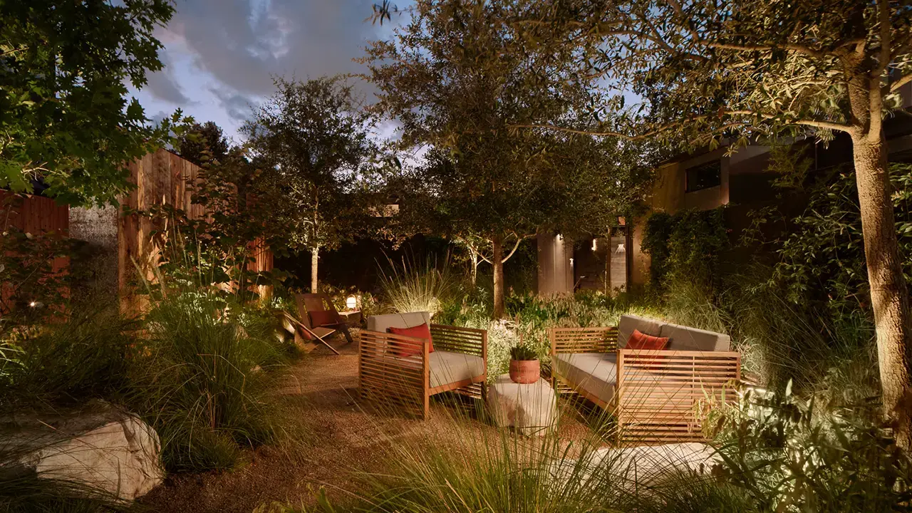 Frame Hotel SoCo — garden seating at dusk
